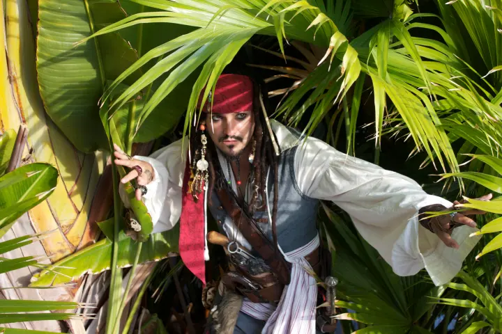 a person standing next to a palm tree