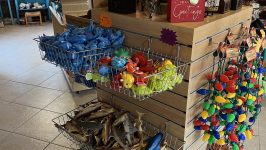 Pirate-themed gift shop with toys, figurines, and colorful lights on display.