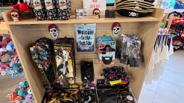 Store display with pirate hats, toy swords, and skull-themed items.