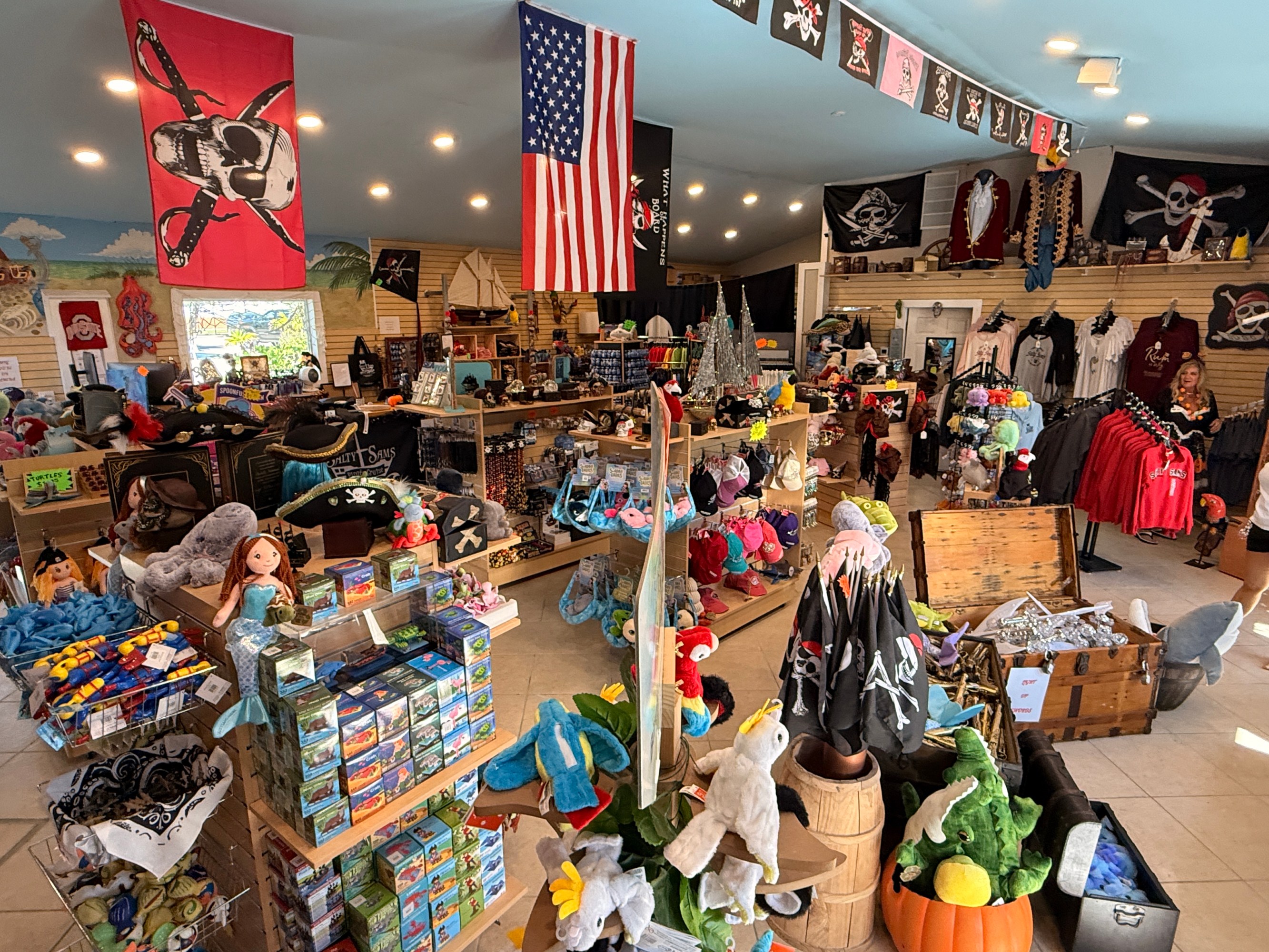 Pirate-themed gift shop with various merchandise and pirate flags on display.