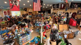 Pirate-themed gift shop with various merchandise and pirate flags on display.