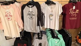Various graphic t-shirts on display in a store with nautical and pirate themes.